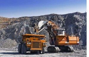 Loading the gold ore into heavy dump truck at the opencast mining